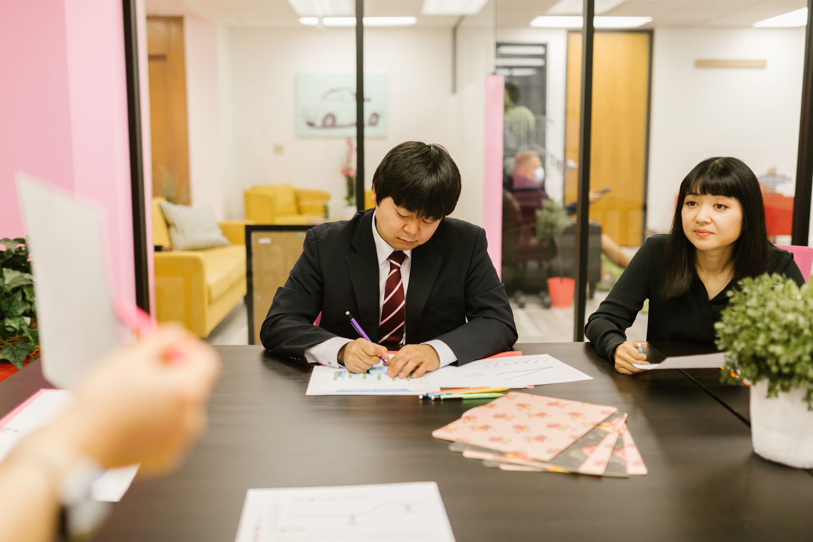 Colleagues discussing information in an office.